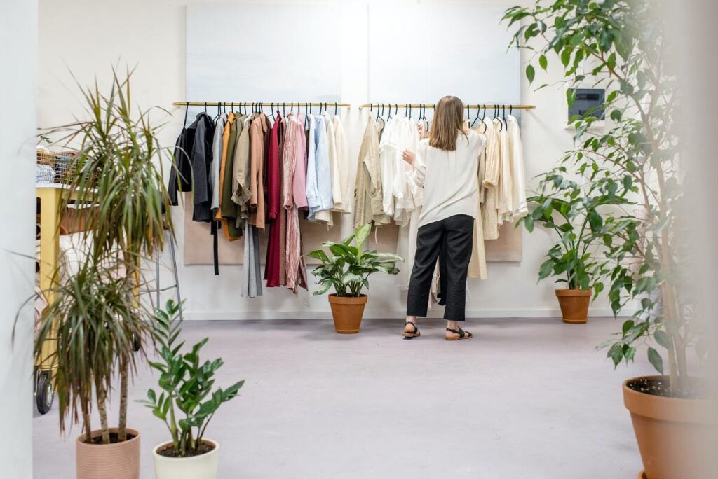 A Women Strictly Checking The Quality Of Different Clothing Styles