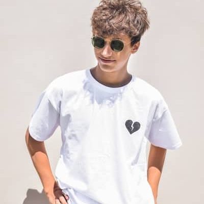 A Boy Wearing Custom T Shirts With A Heartbroken Printed Pattern